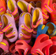 Production overstock physiological fisherman sandals piled up, in various colors