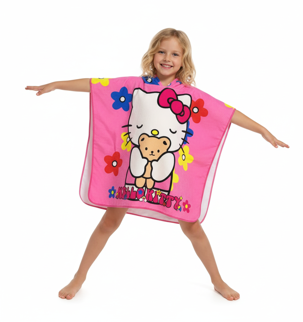 Girl wearing the Hello Kitty 2 poncho towel, pink with Hello Kitty and a teddy bear, hooded, in microfiber