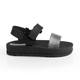 Black Moderniña platform sandal for girls with a glittery strap and hook-and-loop closure, side view, non-slip sole