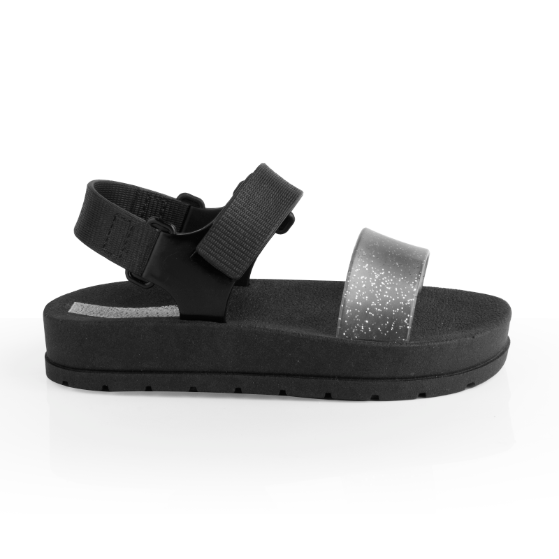 Sandalia Moderniña negra para niña, de plataforma con tira con brillo y velcro, vista de lado, suela antideslizante